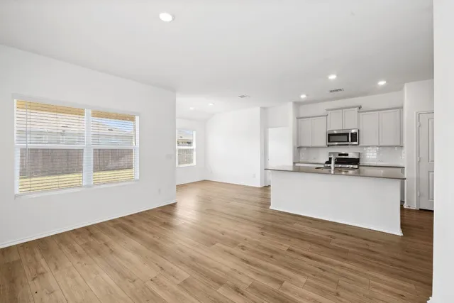 a view of kitchen with wooden floor and window