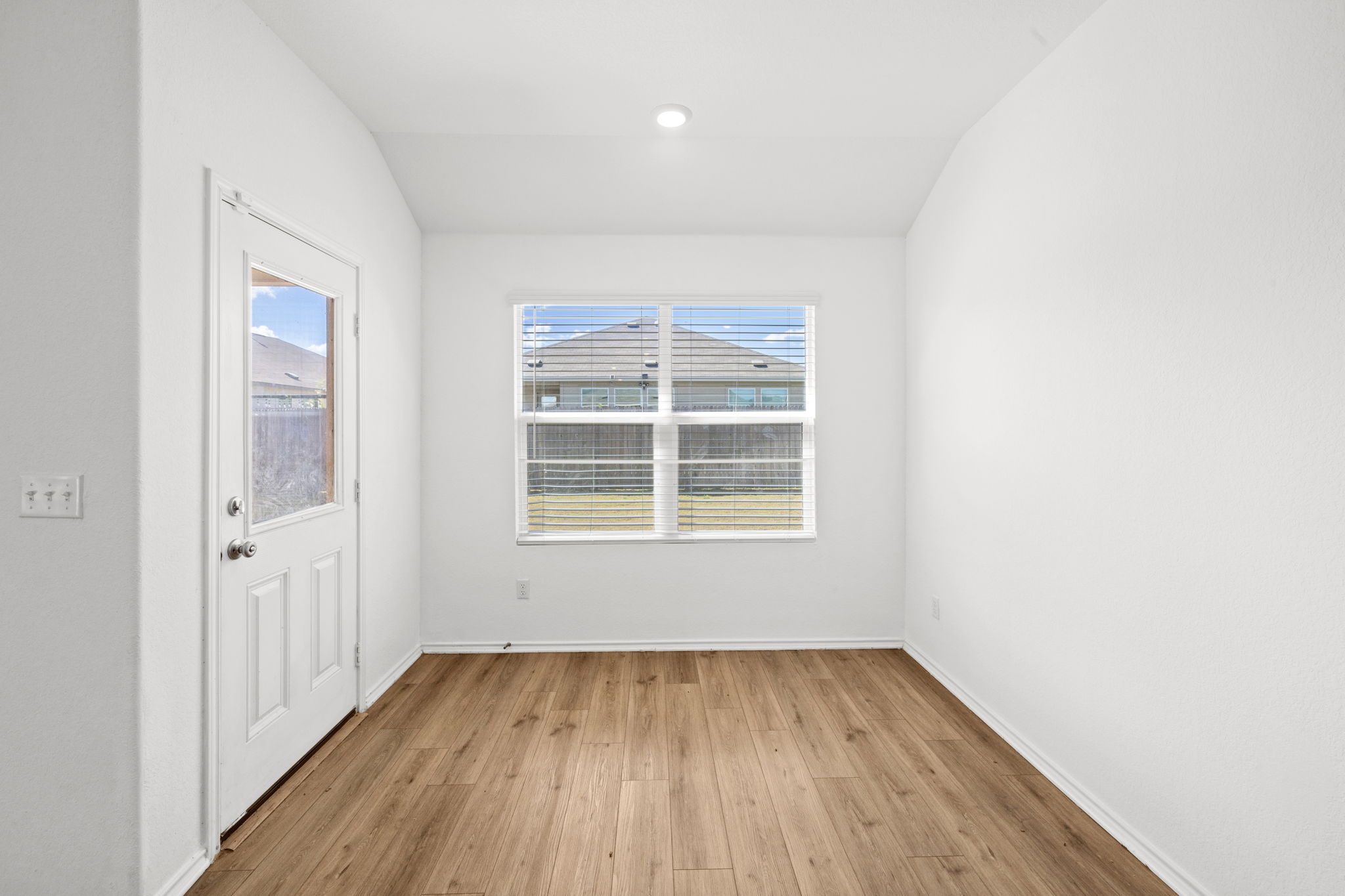 110 Madrid Kyle, TX 78640 - Photo 12 of 29 an empty room with wooden floor and windows