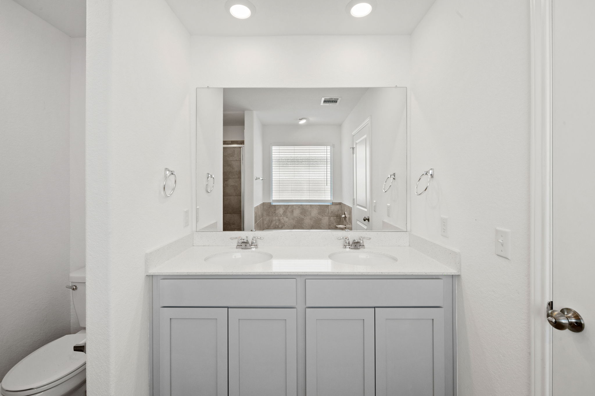 110 Madrid Kyle, TX 78640 - Photo 18 of 29 a bathroom with a sink a toilet and a mirror