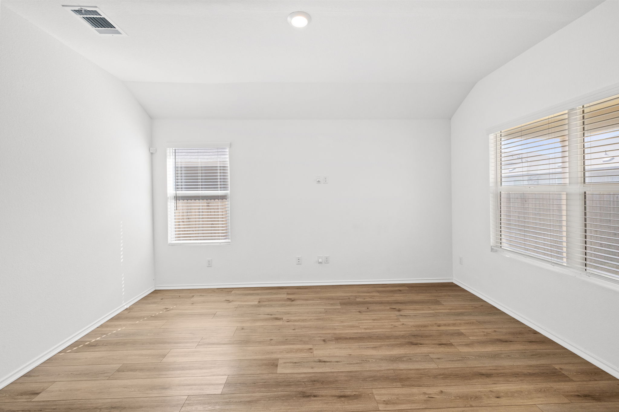 110 Madrid Kyle, TX 78640 - Photo 9 of 29 wooden floor in an empty room with a window