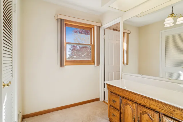 a bathroom with a sink a vanity and a large mirror