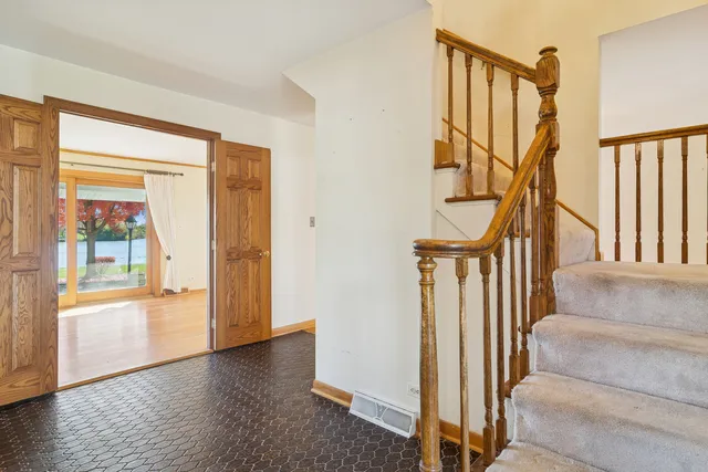 a view of an entryway with wooden floor and door