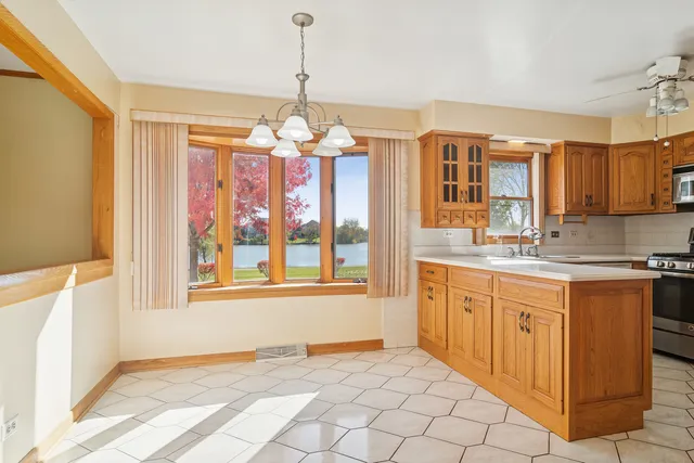 a view of a kitchen with granite countertop stainless steel appliances a sink and a window