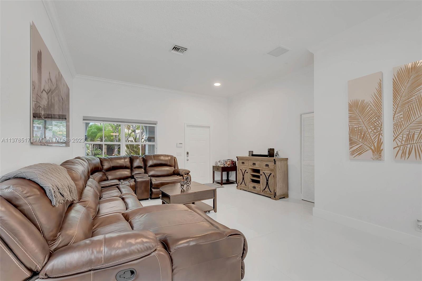 4115 Sabal Ridge Circle Weston, FL 33331 - Photo 11 of 31 a living room with furniture and a flat screen tv
