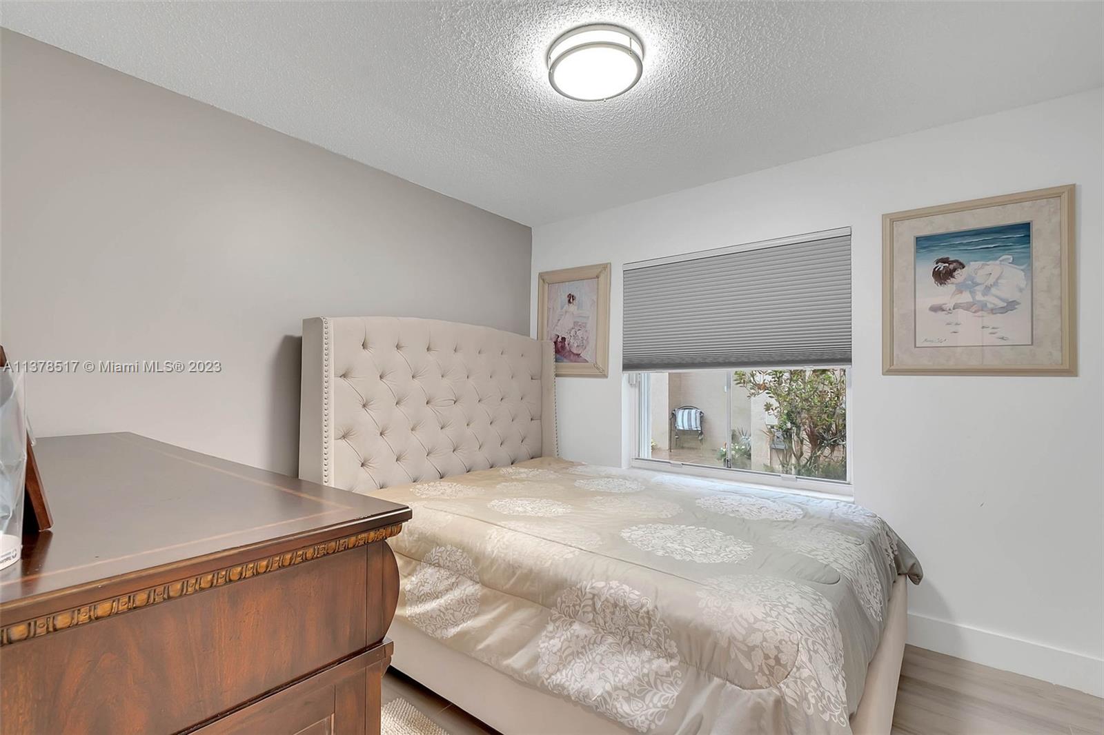 4115 Sabal Ridge Circle Weston, FL 33331 - Photo 19 of 31 a bedroom with a bed and a night stand