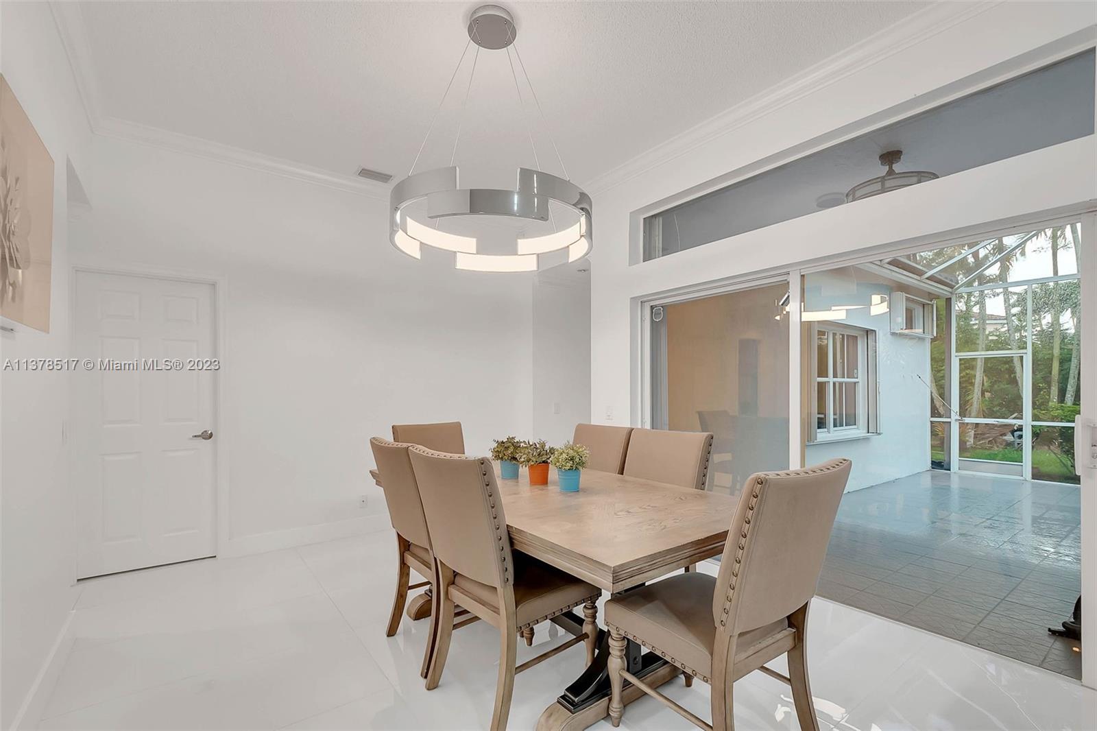 4115 Sabal Ridge Circle Weston, FL 33331 - Photo 8 of 31 a view of a dining room with furniture and chandelier