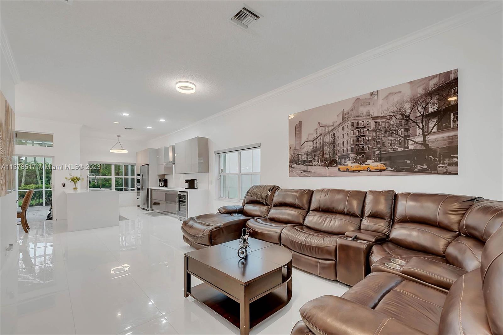 4115 Sabal Ridge Circle Weston, FL 33331 - Photo 9 of 31 a living room with furniture a rug and a painting on the wall