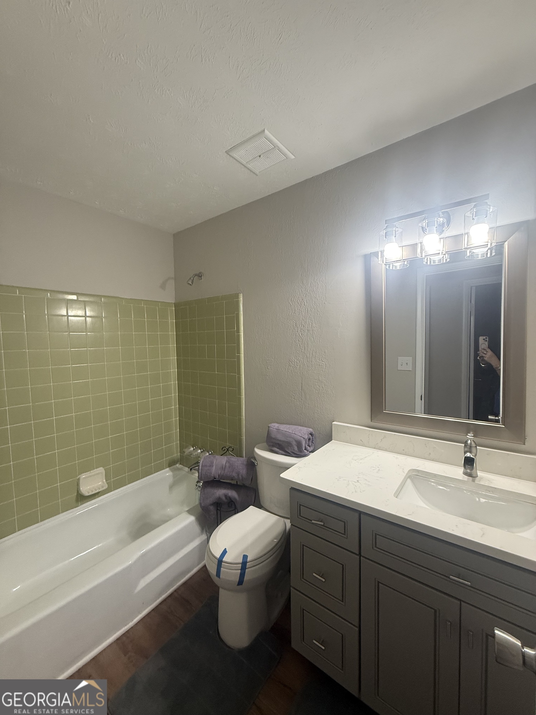 152 Club Circle Stockbridge, GA 30281 - Photo 14 of 17 a bathroom with a double vanity sink toilet mirror and bathtub