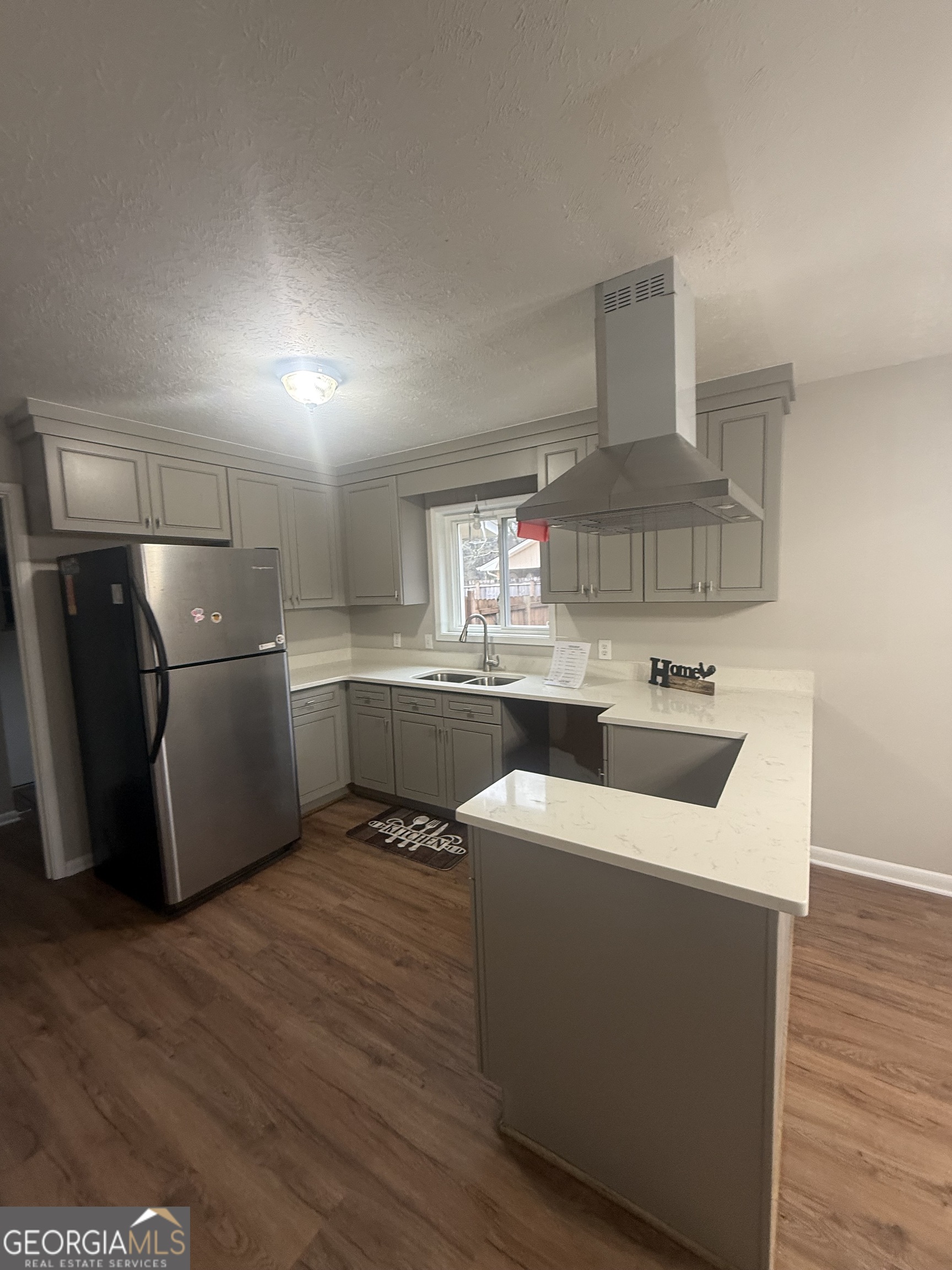 152 Club Circle Stockbridge, GA 30281 - Photo 2 of 17 a kitchen with stainless steel appliances a sink a stove a refrigerator and cabinets