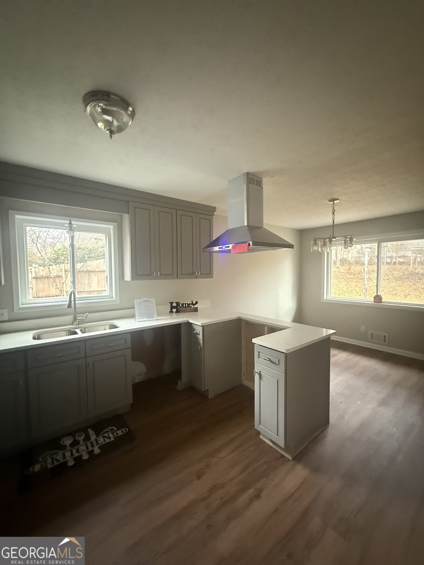 152 Club Circle Stockbridge, GA 30281 - Photo 3 of 17 a kitchen with a sink cabinets and wooden floor
