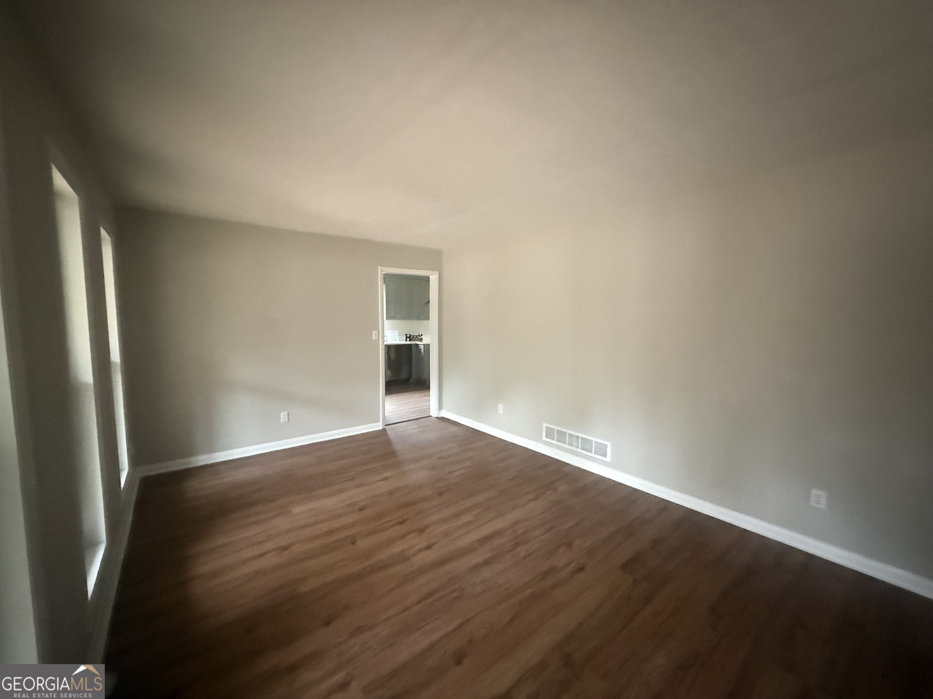 152 Club Circle Stockbridge, GA 30281 - Photo 4 of 17 an empty room with wooden floor and windows