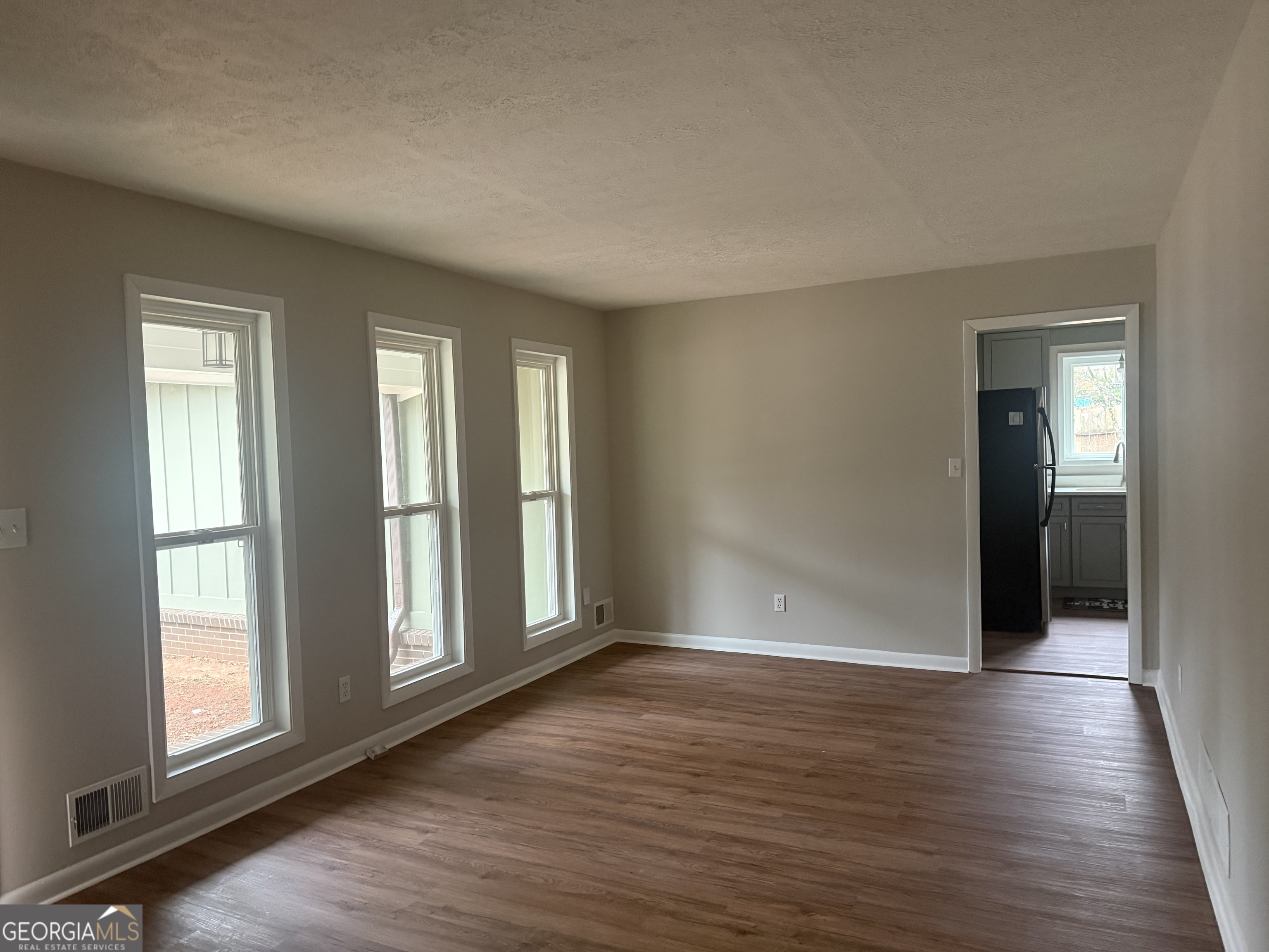 152 Club Circle Stockbridge, GA 30281 - Photo 5 of 17 an empty room with wooden floor and windows