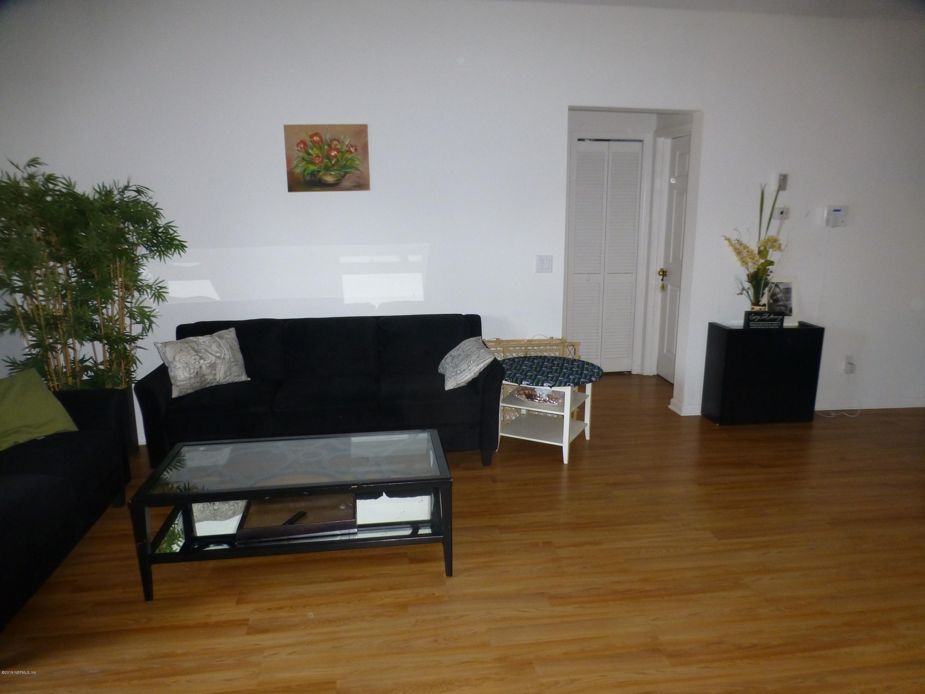 3690 Kirkpatrick Circle, Unit 77 Jacksonville, FL 32210 - Photo 3 of 9 a living room with furniture and a wooden floor