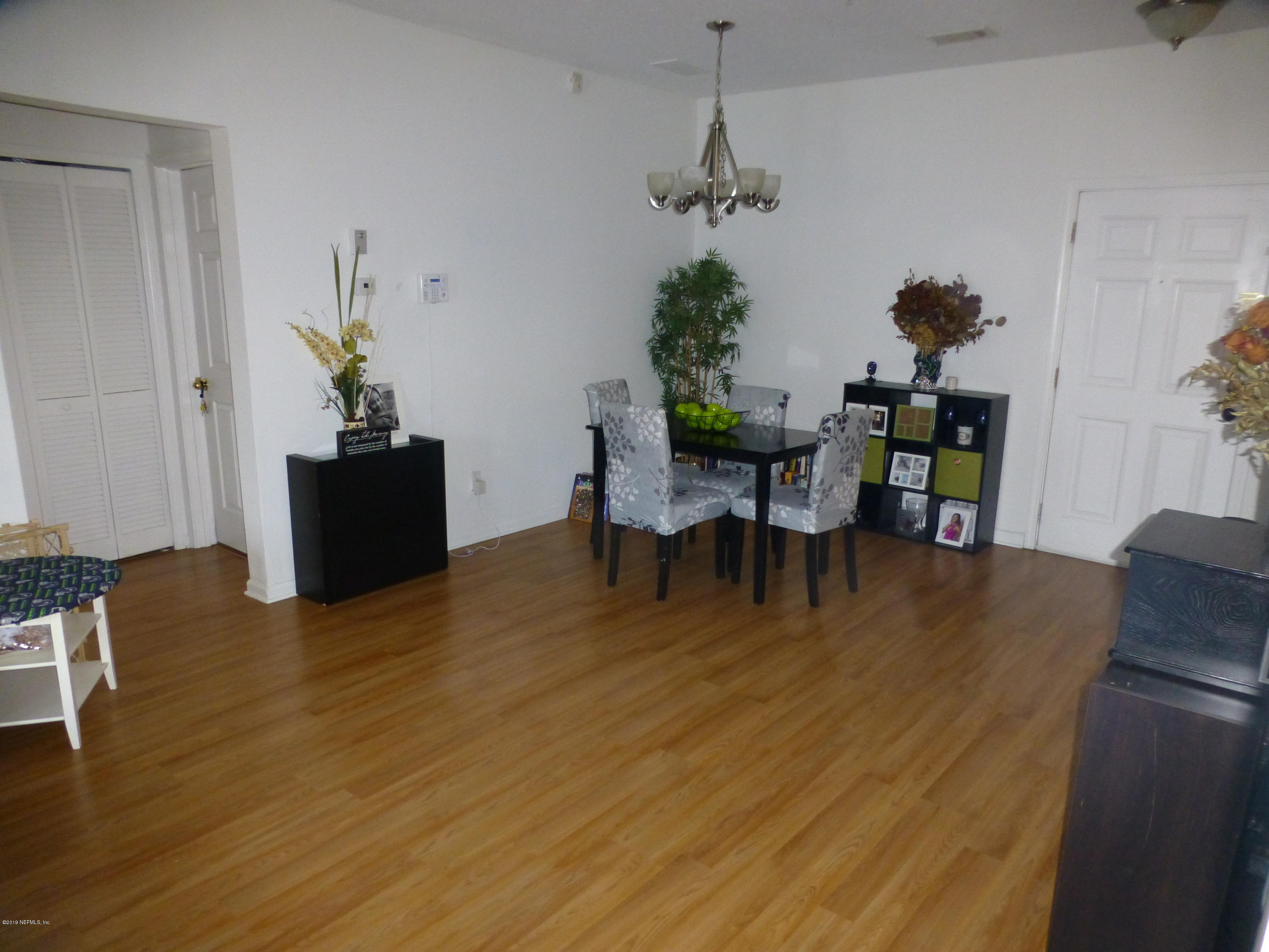 3690 Kirkpatrick Circle, Unit 77 Jacksonville, FL 32210 - Photo 4 of 9 a view of a dining room with furniture and wooden floor