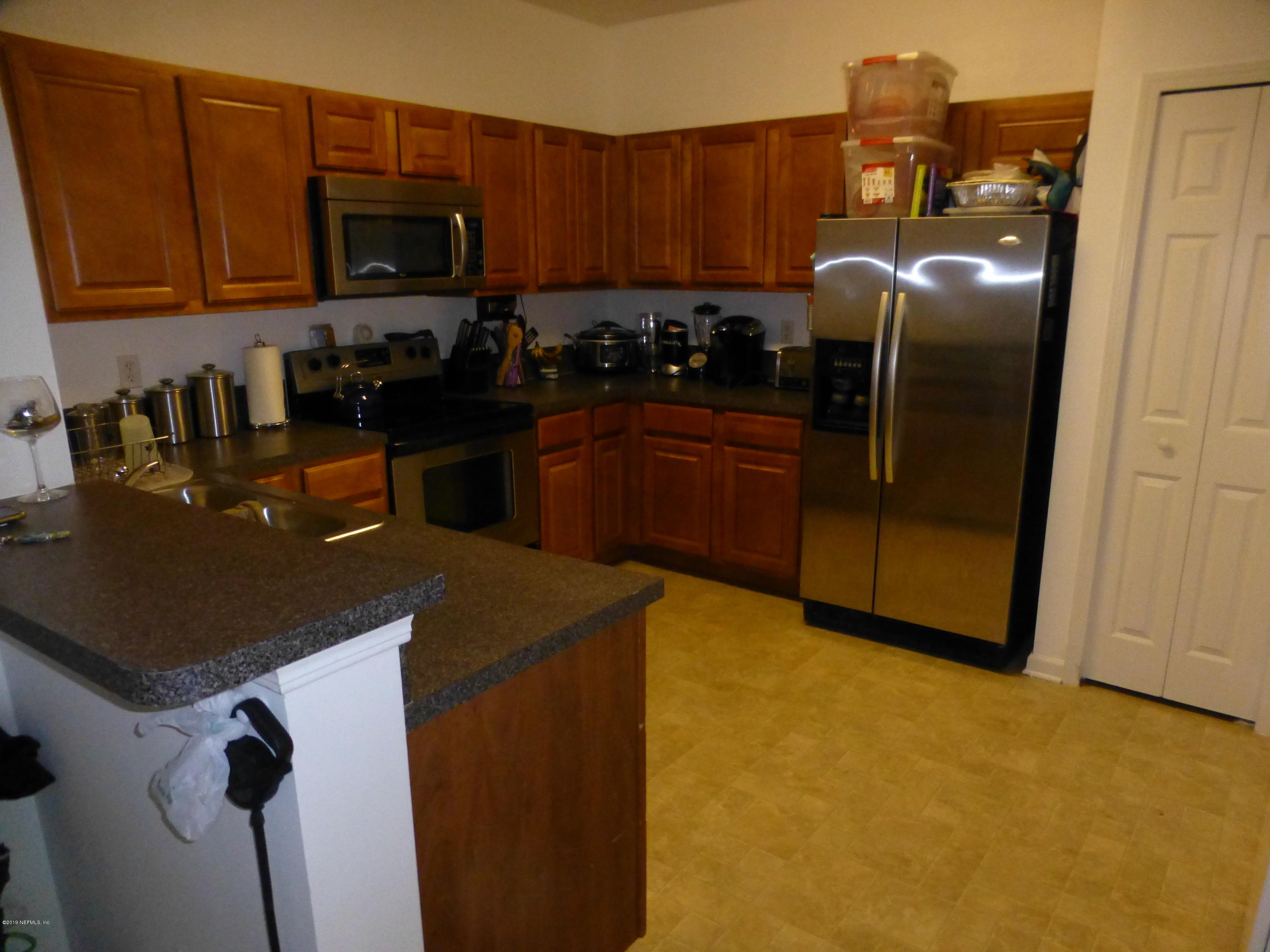 3690 Kirkpatrick Circle, Unit 77 Jacksonville, FL 32210 - Photo 5 of 9 a kitchen with stainless steel appliances granite countertop a refrigerator a stove top oven a sink and dishwasher