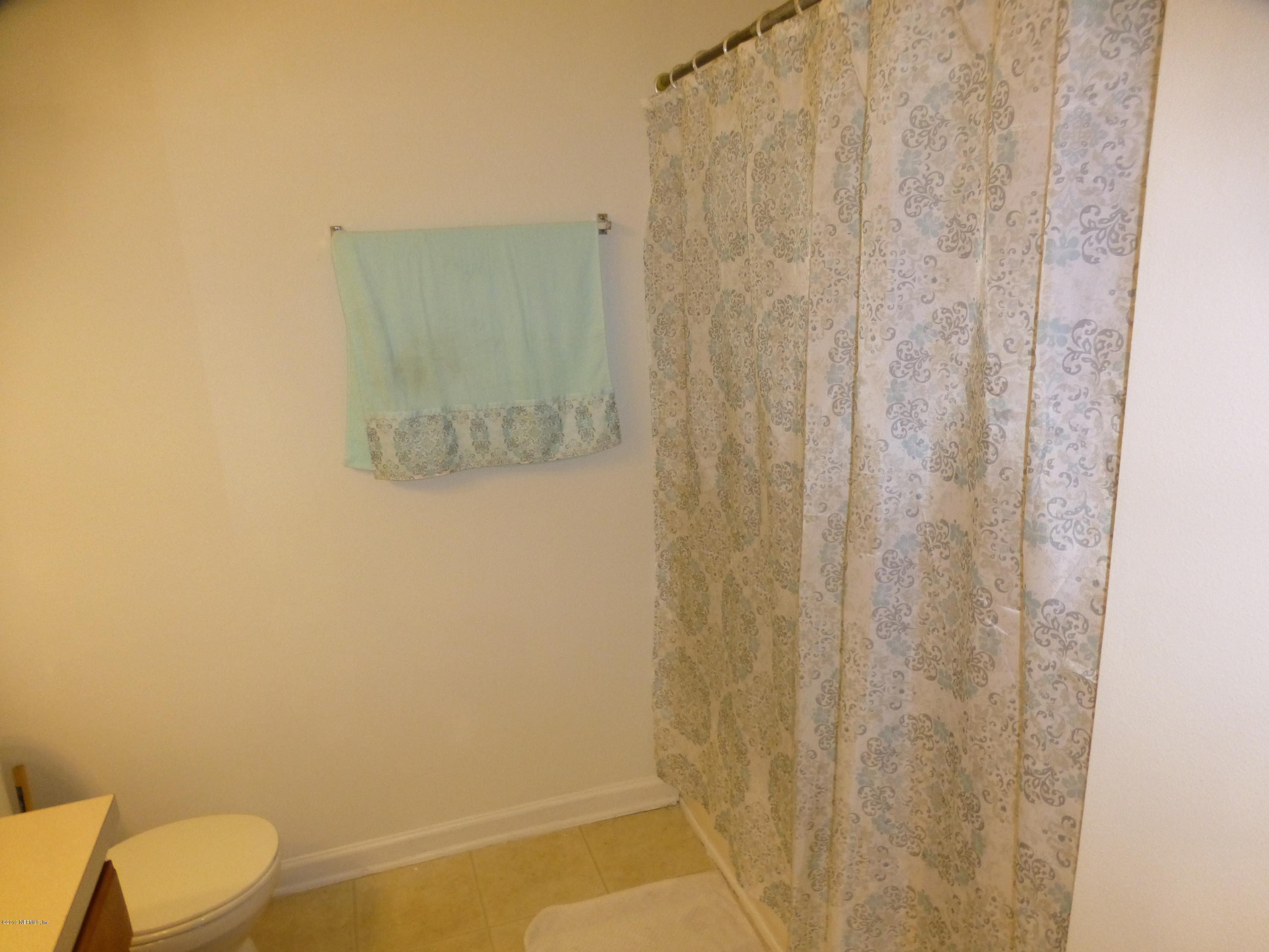 3690 Kirkpatrick Circle, Unit 77 Jacksonville, FL 32210 - Photo 8 of 9 a bathroom with a shower curtain
