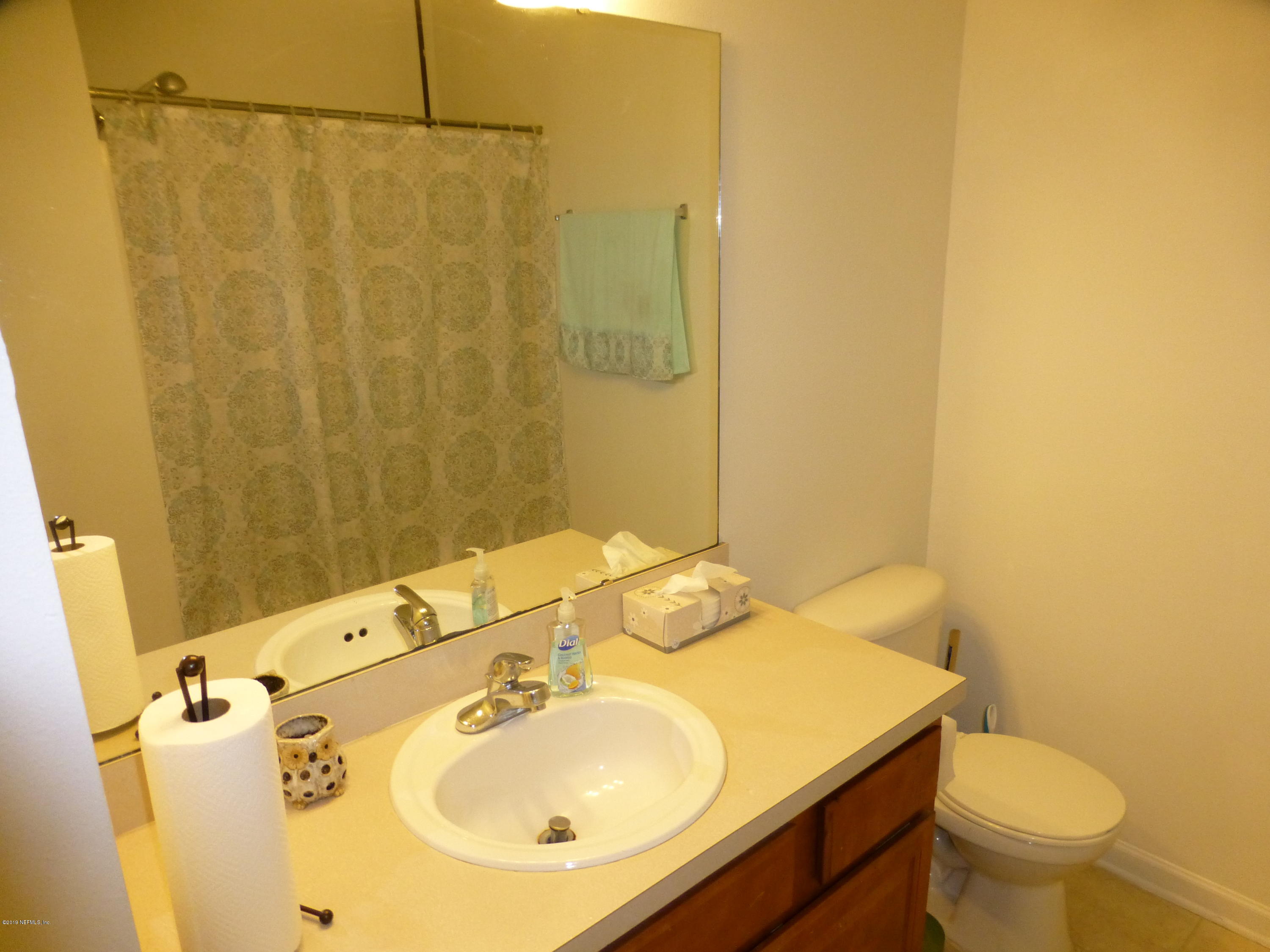 3690 Kirkpatrick Circle, Unit 77 Jacksonville, FL 32210 - Photo 9 of 9 a bathroom with a sink and mirror with toilet