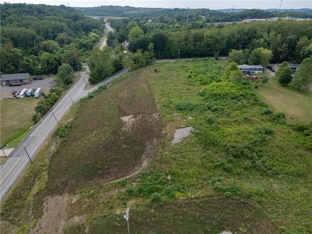 a view of a water pond with green field