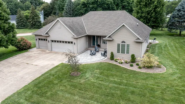 a aerial view of a house with garden and trees