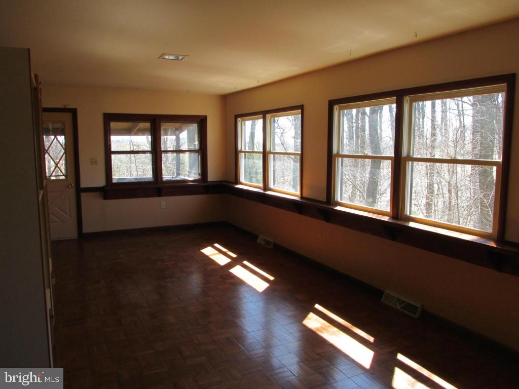 1161 Cider Press Road Manheim, PA 17545 - Photo 38 of 56 a view of an empty room with wooden floor and a window