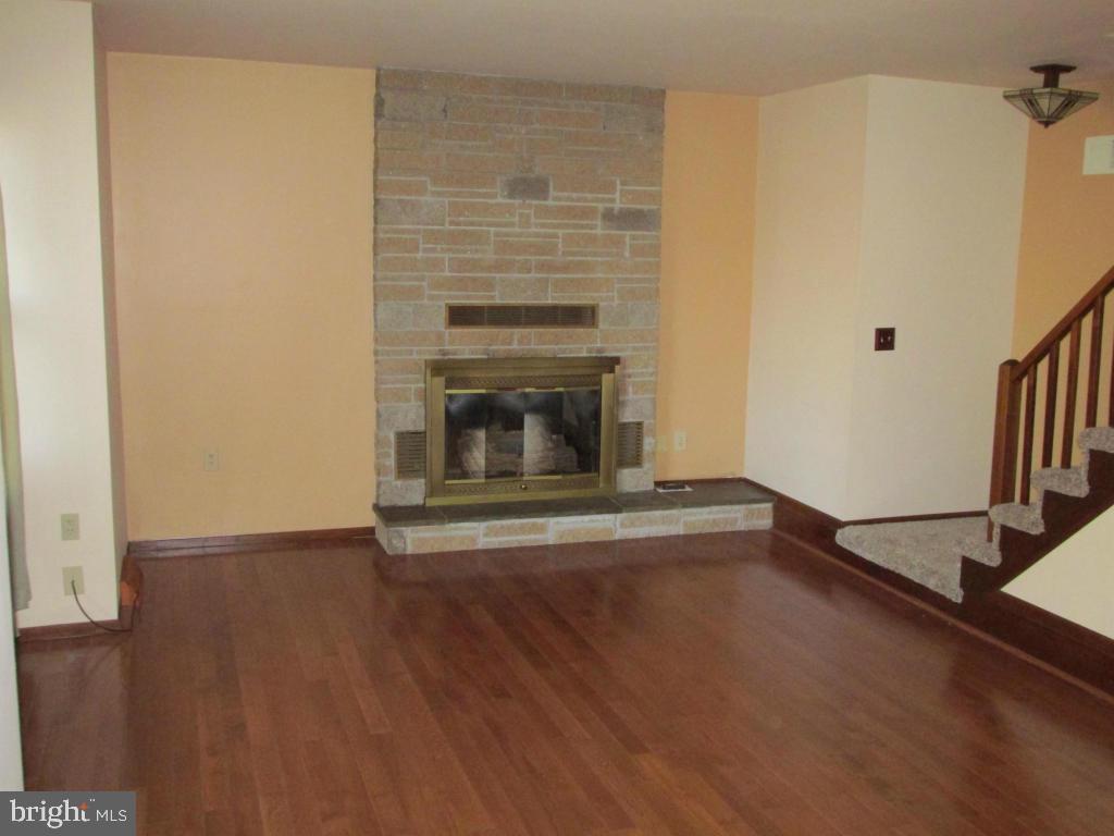 1161 Cider Press Road Manheim, PA 17545 - Photo 6 of 56 a view of empty room with wooden floor and fireplace
