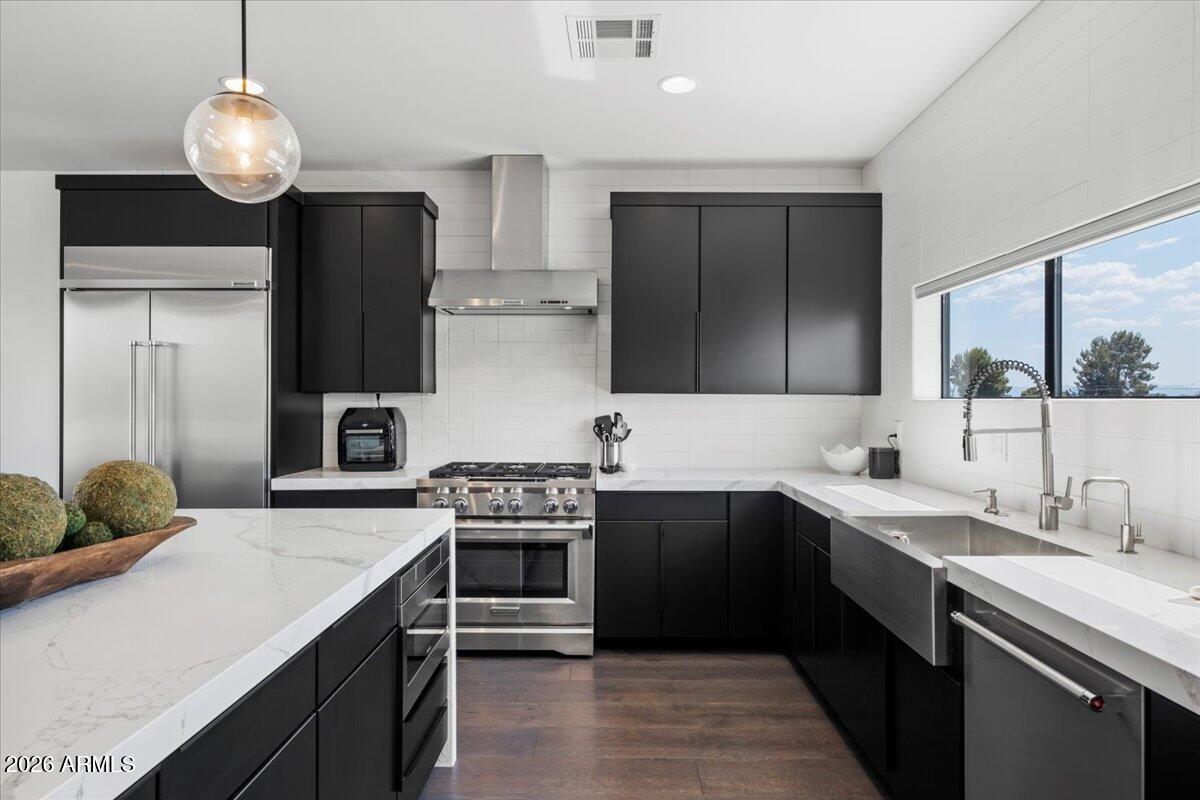 4331 North 27th Place Phoenix, AZ 85016 - Photo 10 of 33 a kitchen with stainless steel appliances a sink stove and refrigerator