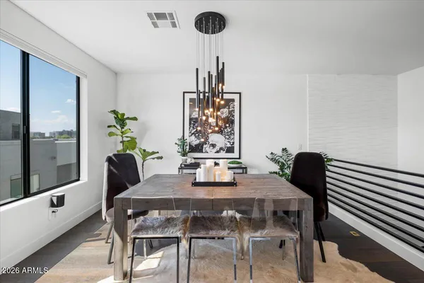 a living room with furniture kitchen view and a refrigerator