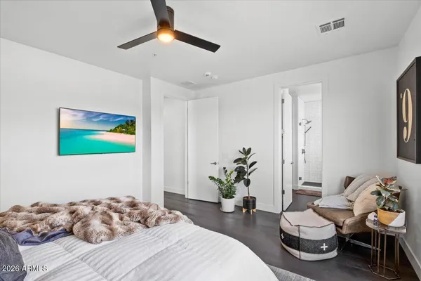 a bedroom with a bed mirror and window