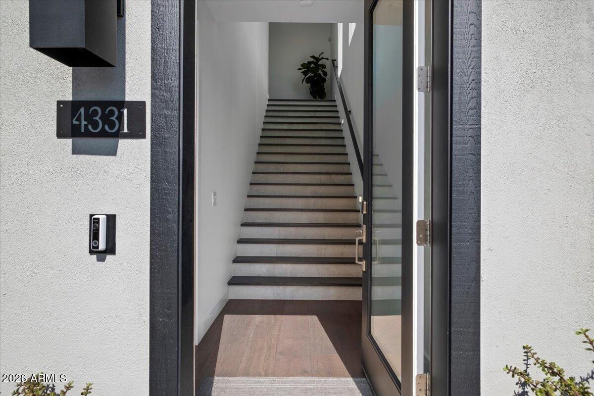 4331 North 27th Place Phoenix, AZ 85016 - Photo 2 of 33 a view of a hallway with wooden floor and stairs