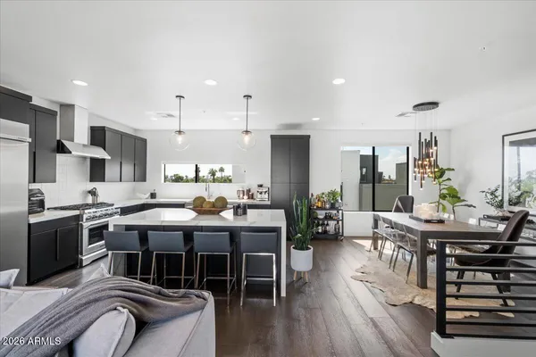 a living room with furniture kitchen view and a couch