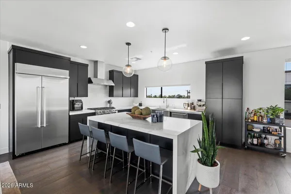 a kitchen with stainless steel appliances granite countertop a stove and refrigerator
