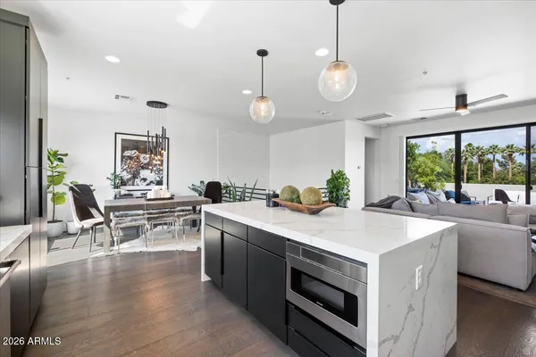 a kitchen with a dining table chairs stove and white cabinets