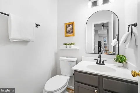 a bathroom with a sink a toilet and mirror