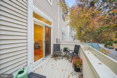 a balcony with wooden floor and furniture