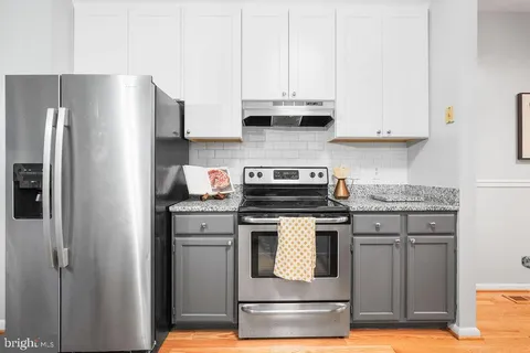 a kitchen with stainless steel appliances granite countertop a stove and a refrigerator