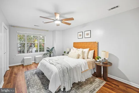 a bedroom with a bed and wooden floor