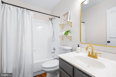 a bathroom with a shower curtain and a toilet