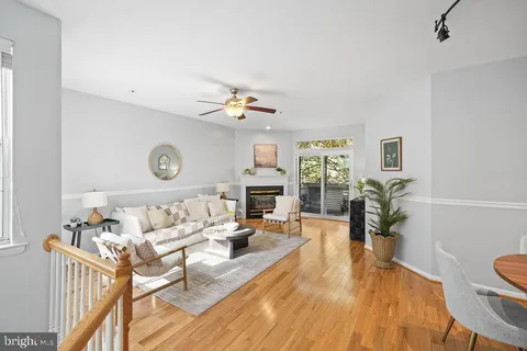 a living room with furniture fireplace and wooden floor