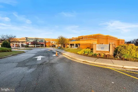 a blue swimming pool with outdoor seating and yard