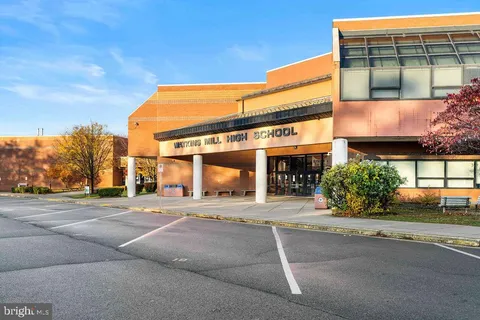 a view of a city street with tall buildings