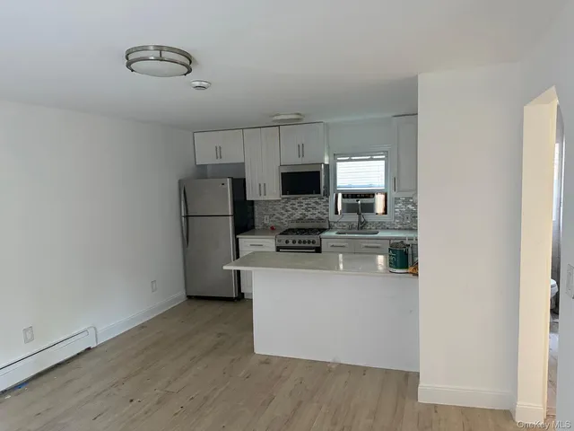 a kitchen with stainless steel appliances granite countertop a refrigerator a stove top oven a sink and dishwasher