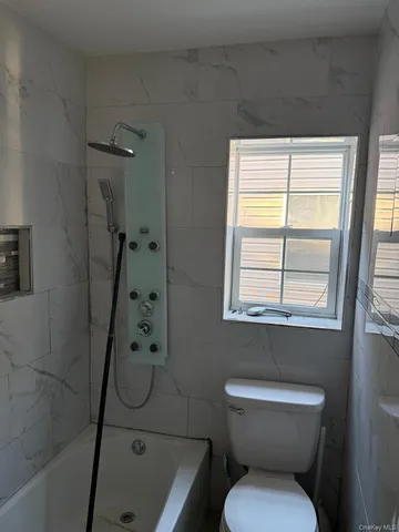 a bathroom with a toilet sink and shower