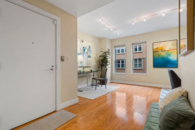 a living room with furniture and a wooden floor