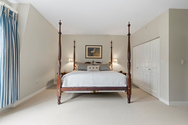 a bed room with a bed and a night stand