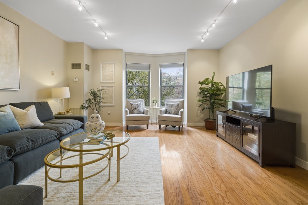 15 Savoy Street, Unit D309 Boston, MA 02118 - Photo 2 of 31 a living room with furniture and a wooden floor