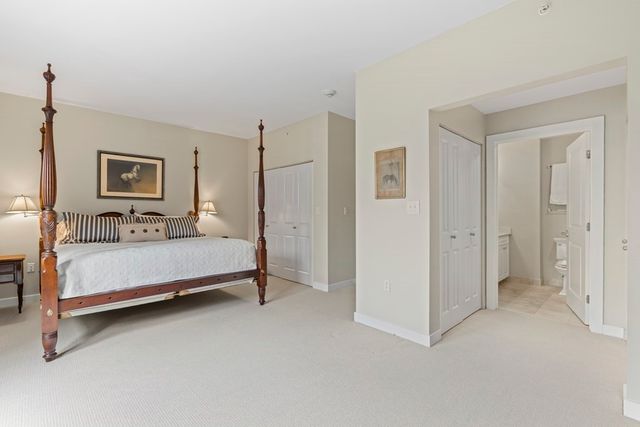 a bedroom with a bed and a night stand