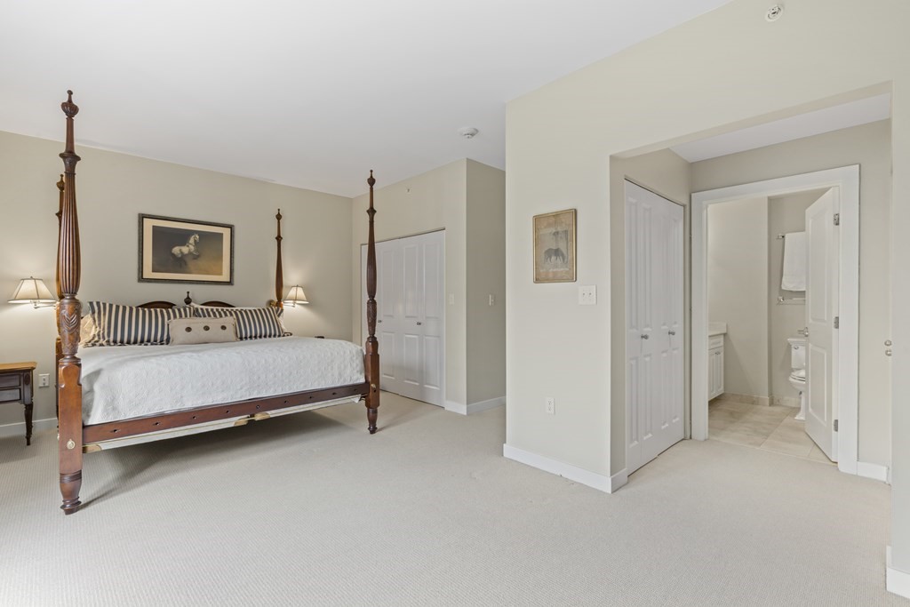 15 Savoy Street, Unit D309 Boston, MA 02118 - Photo 24 of 31 a bedroom with a bed and a night stand