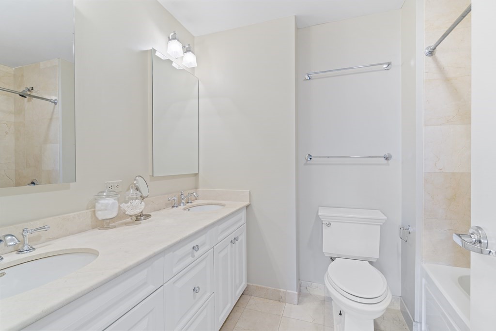 15 Savoy Street, Unit D309 Boston, MA 02118 - Photo 25 of 31 a bathroom with a granite countertop sink a toilet and a mirror