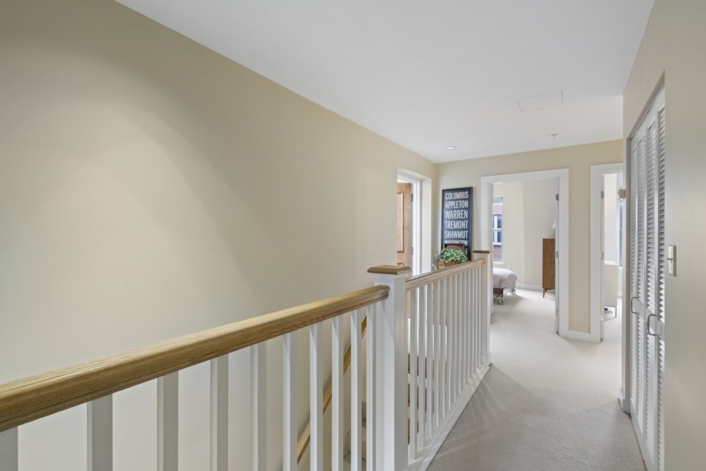 15 Savoy Street, Unit D309 Boston, MA 02118 - Photo 26 of 31 a view of a hallway with white walls and stairs