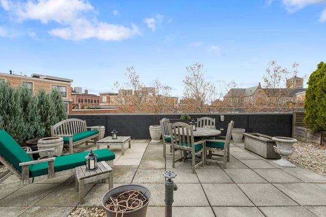 a view of a terrace with furniture and a fire pit
